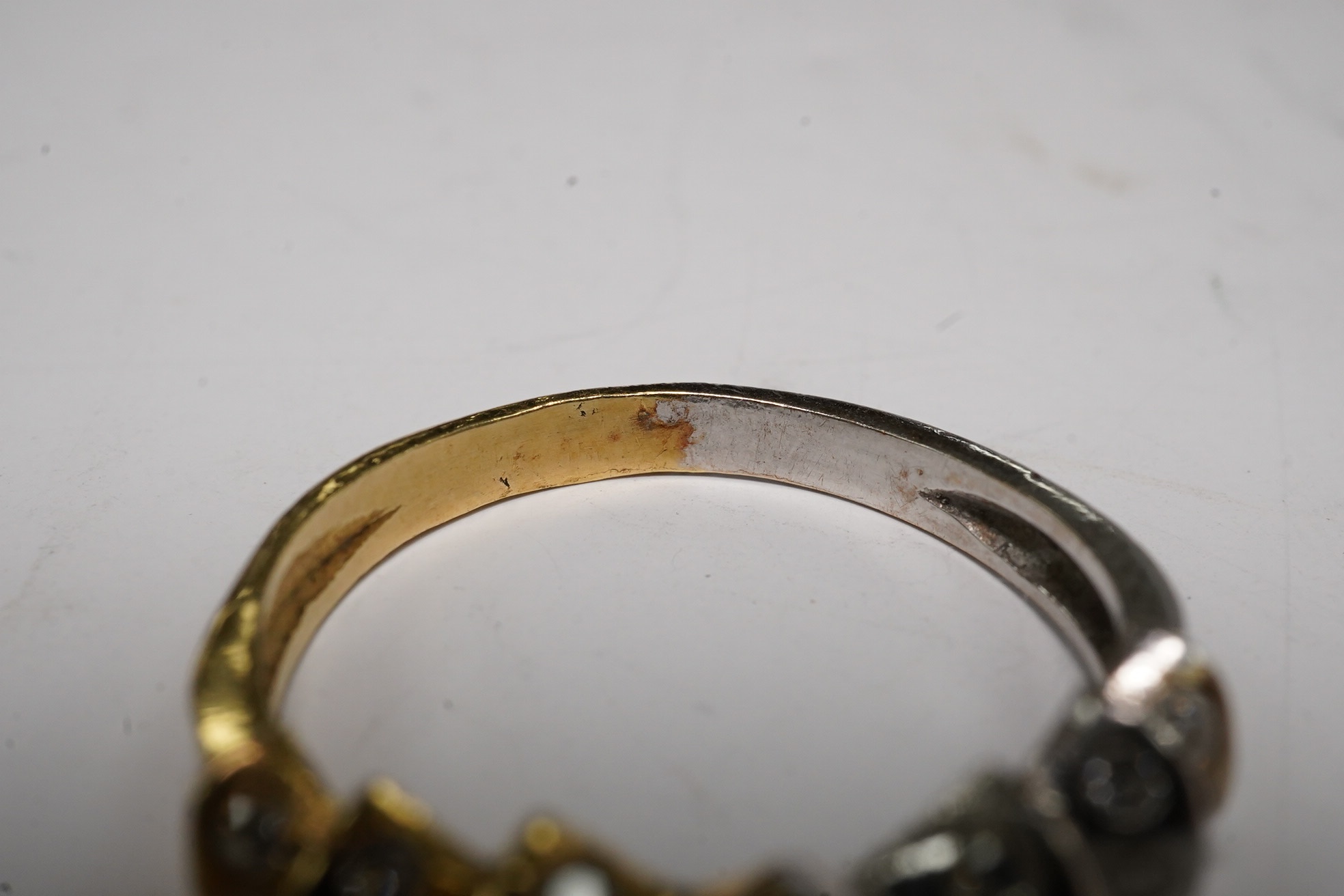 A yellow and white metal and seventeen stone diamond cluster set half hoop ring, size O/P, gross weight 3.3 grams. Condition - fair